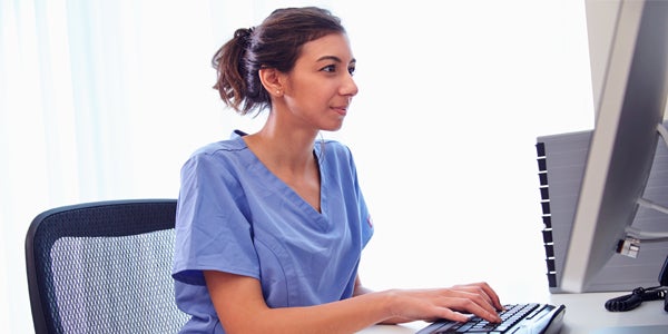 Nurse typing on the computer