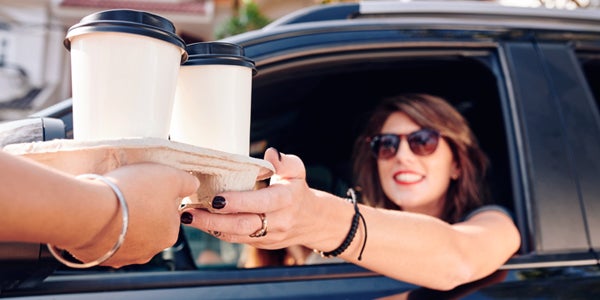 Driver receiving coffee at Drive-thru