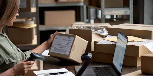 Woman scanning packages to drop ship